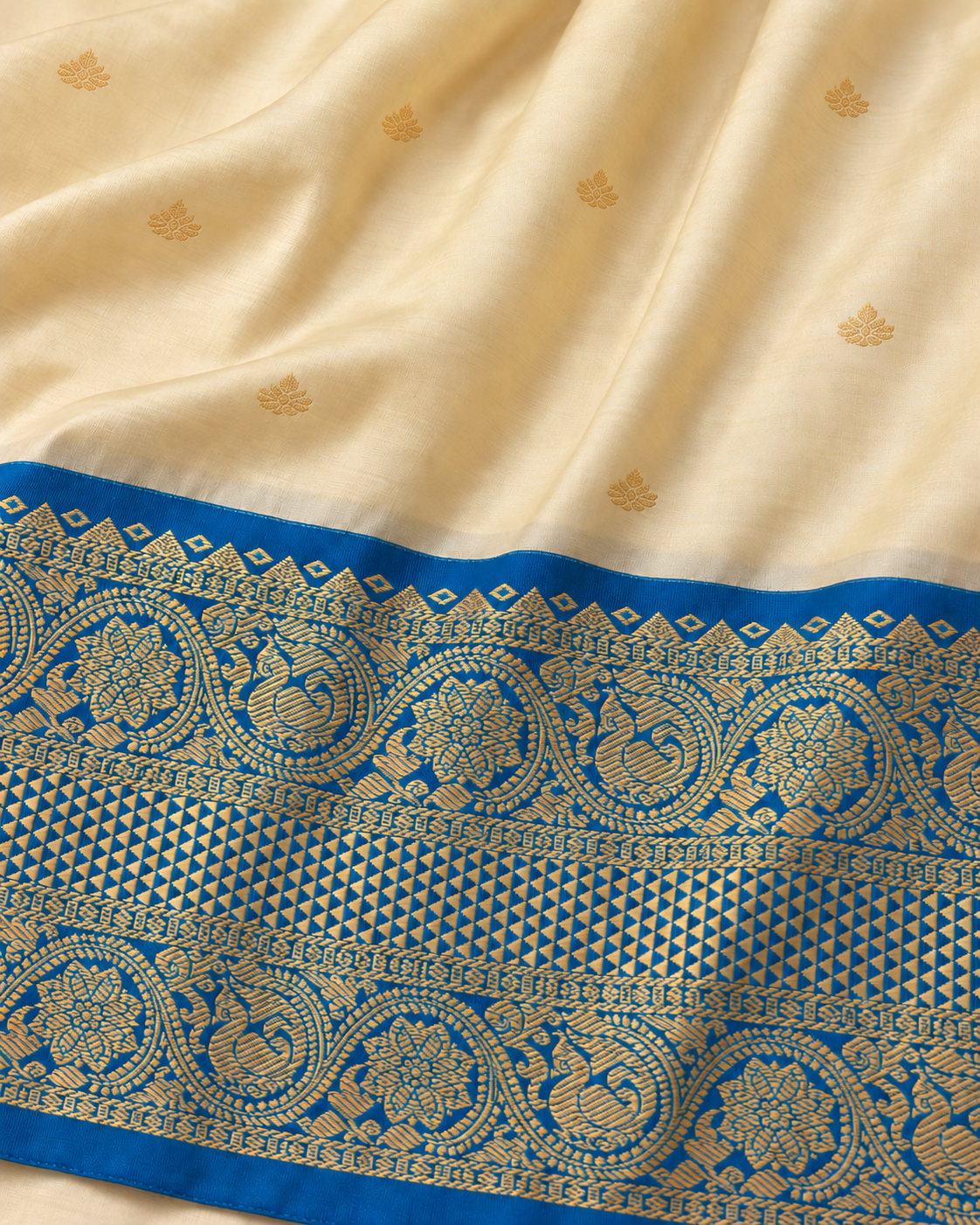 Cream saree body and blue gold border detail