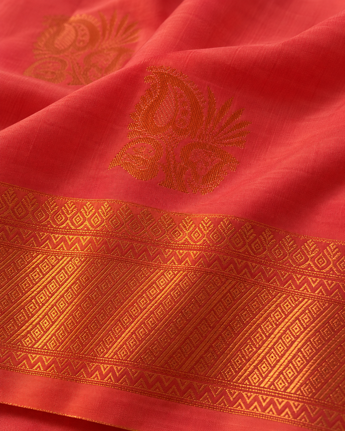 Close-up of copper leaf motif and geometric saree border