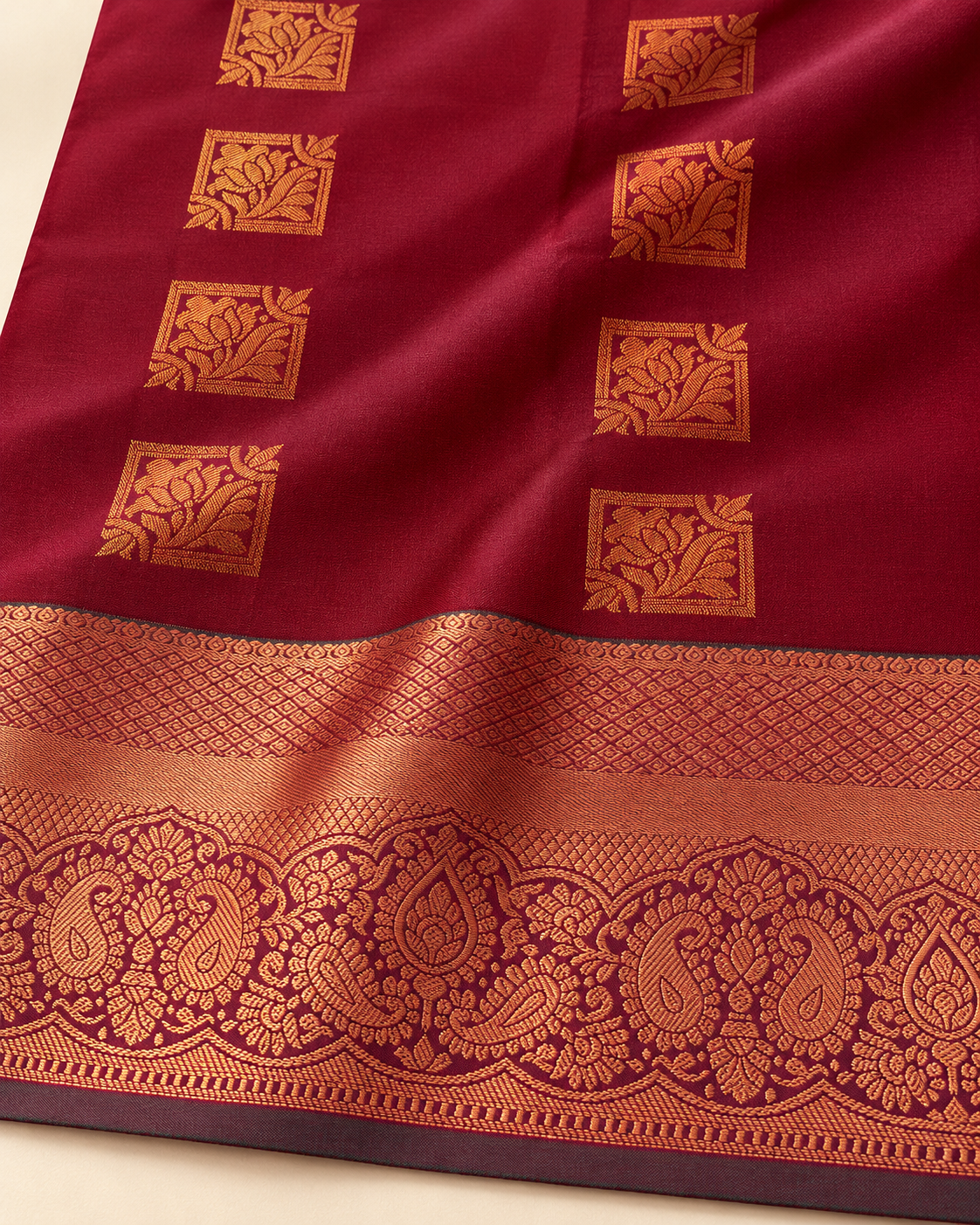 Detail of bordeaux silk floral squares and copper-toned border