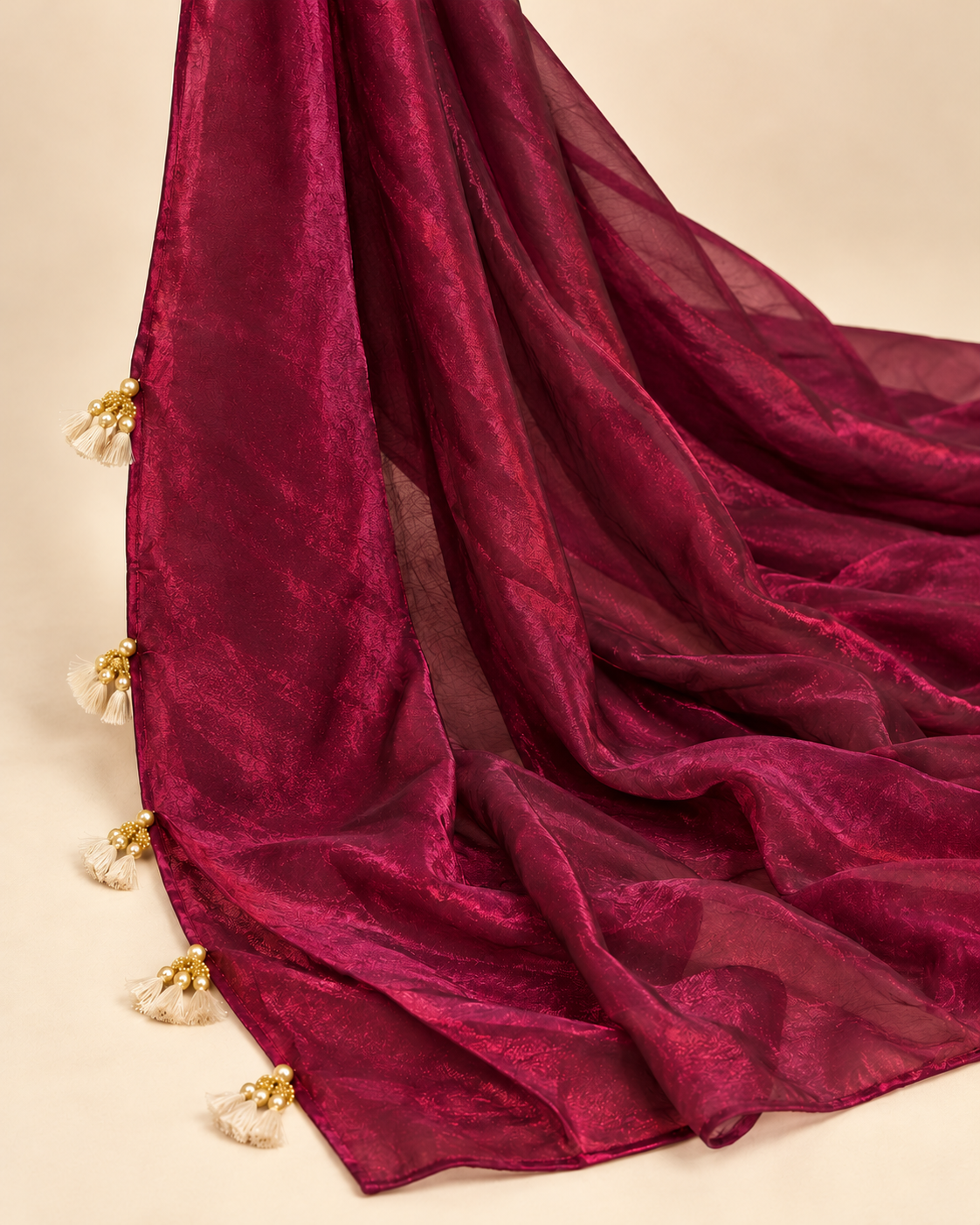 Plain bordeaux shimmering pallu with gold-tone and cream tassels