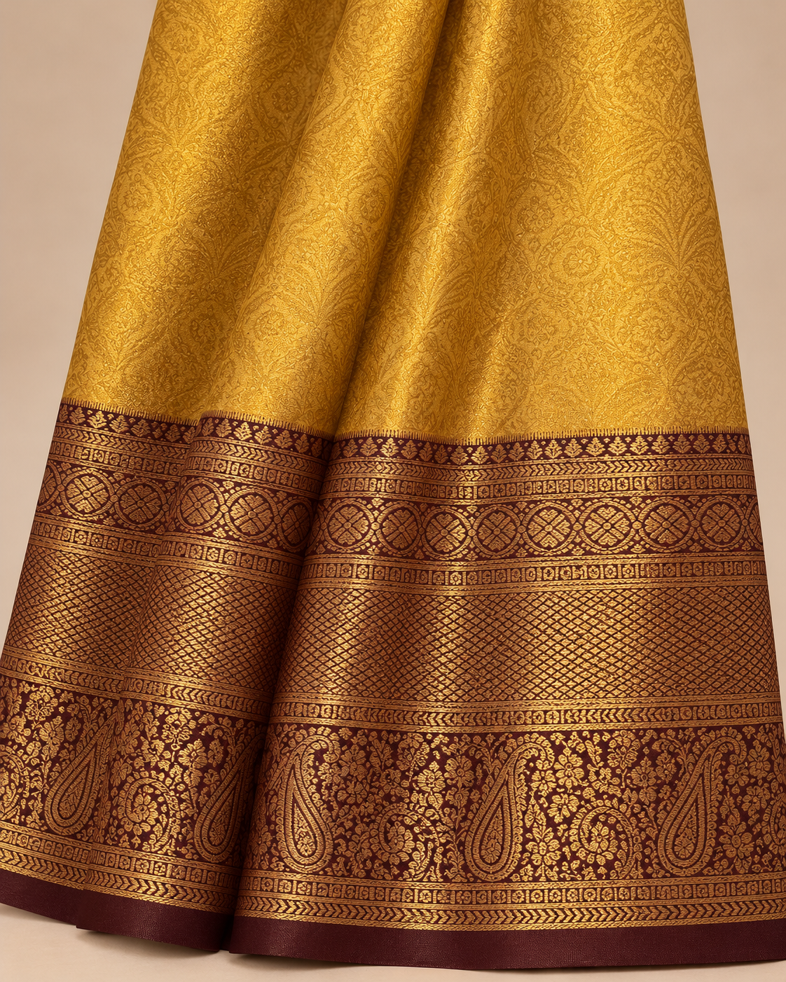 Close-up of golden fabric and burgundy paisley border