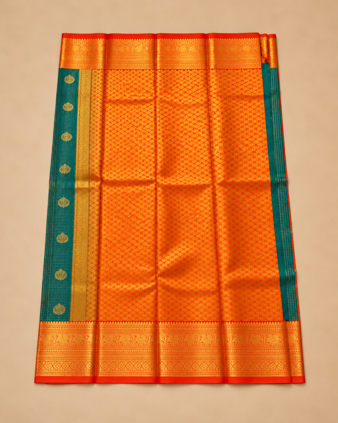 Orange and gold patterned pallu of teal silk saree