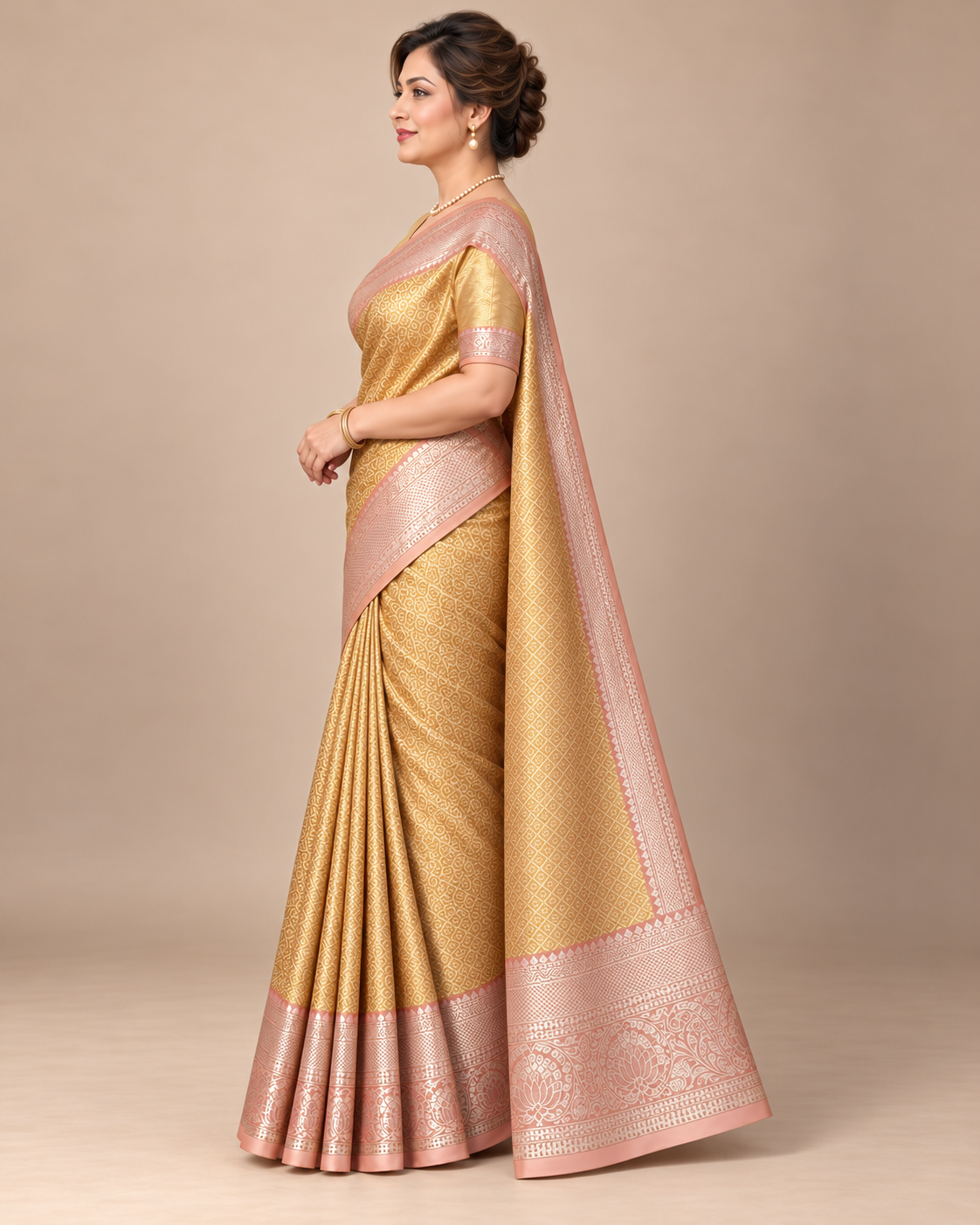 Side view of gold silk saree with blush border
