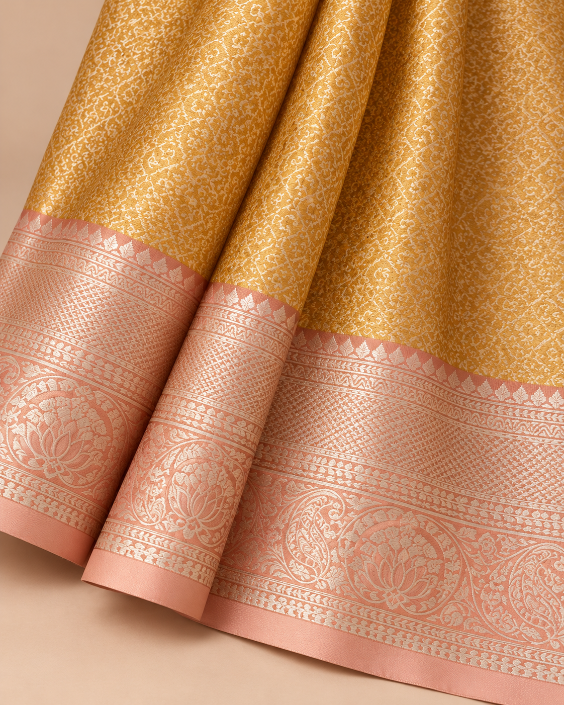 Close-up of gold scroll weave and blush floral border