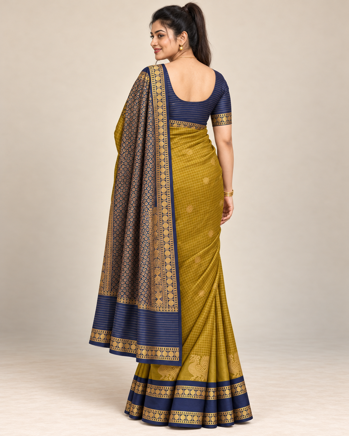 Natural rear view of mustard silk saree with navy patterned pallu