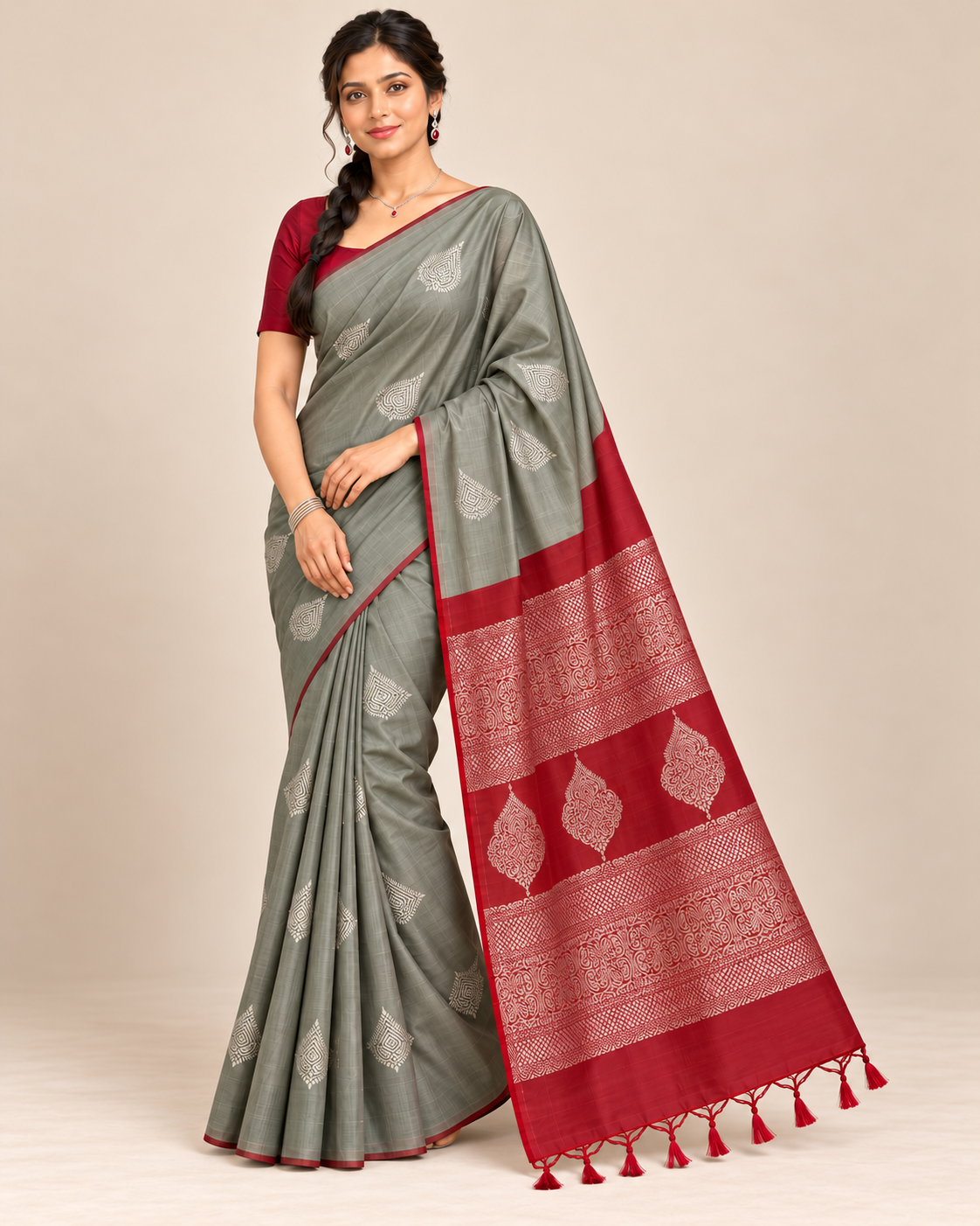 Three-quarter view of borderless grey and red silk saree
