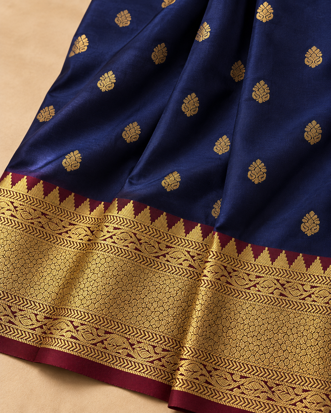 Small gold motif and border detail — navy blue silk saree