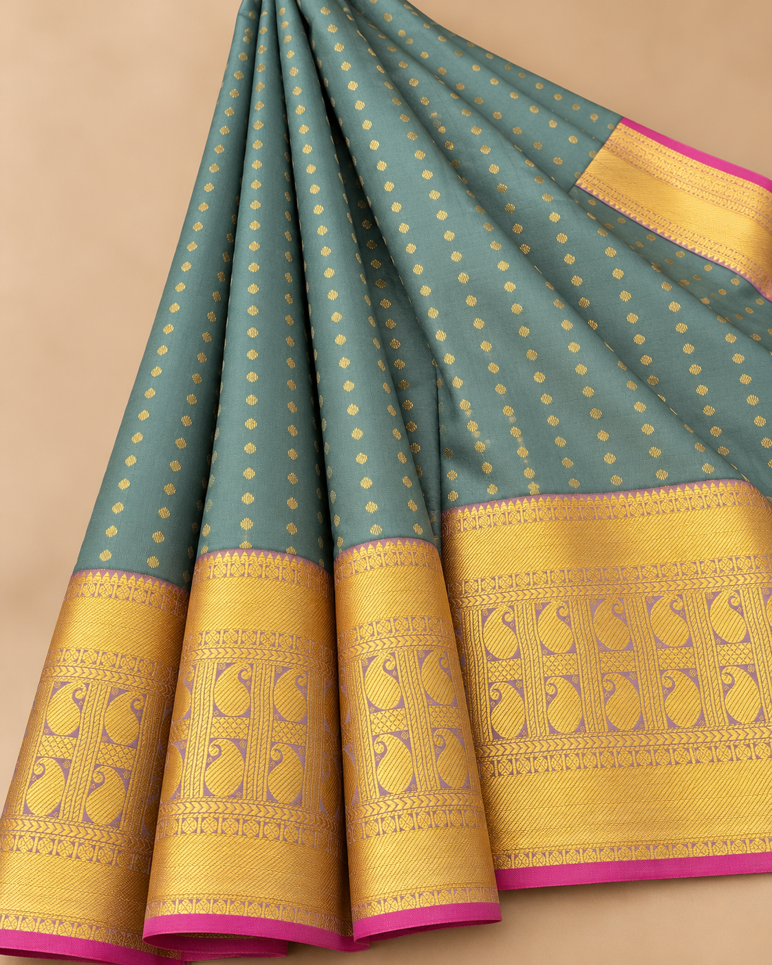 Gold dot and paisley border detail — sage green silk saree