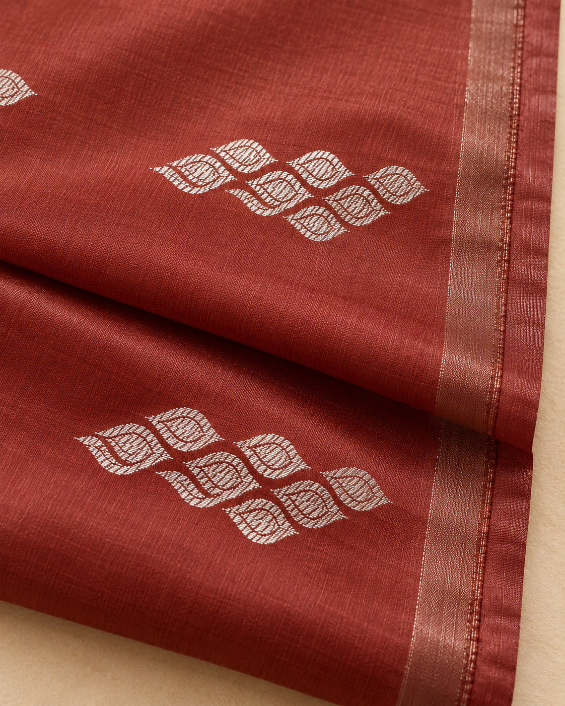 Silver leaf motif detail — rust brown silk saree