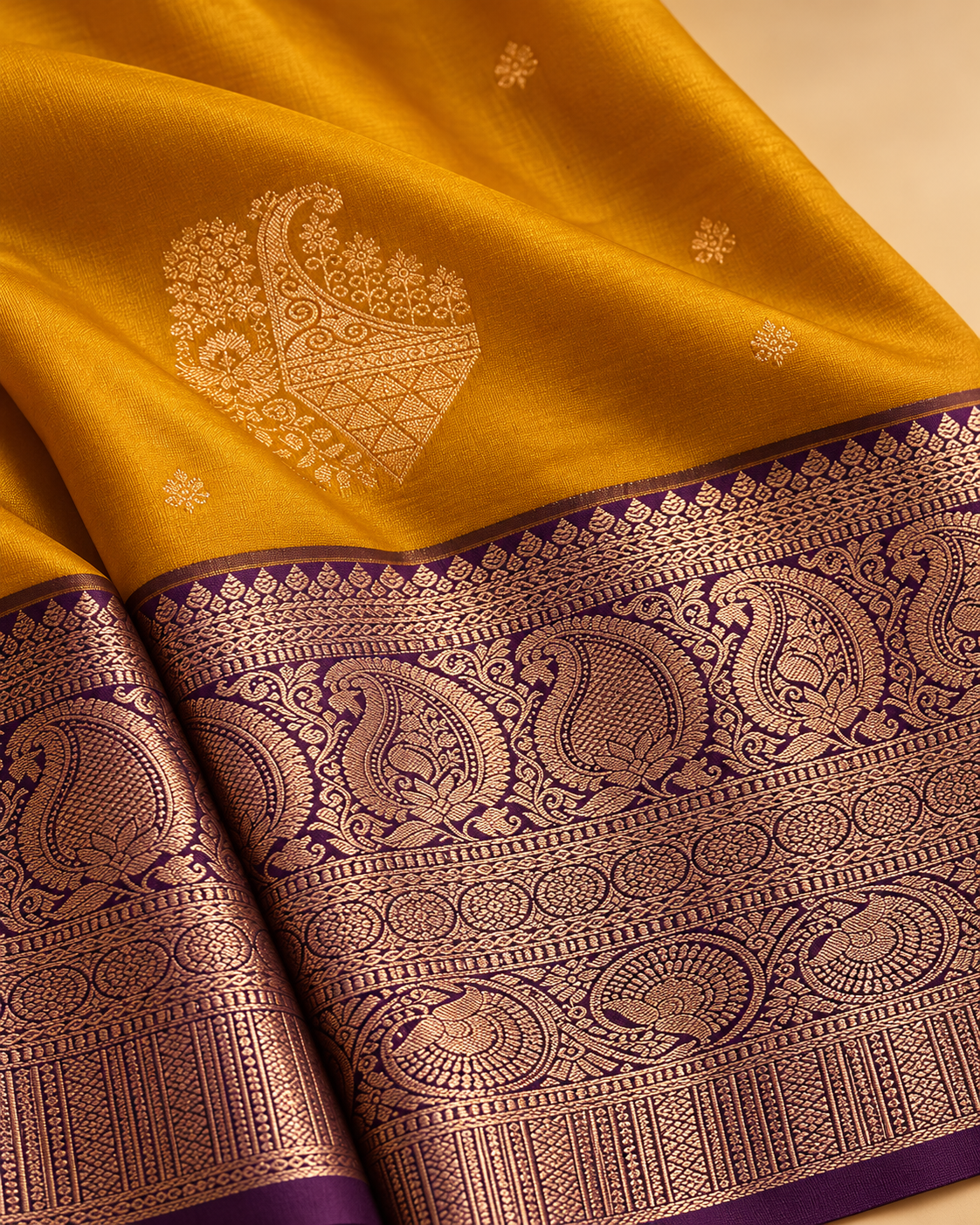 Woven motifs and border detail — mustard and purple silk saree