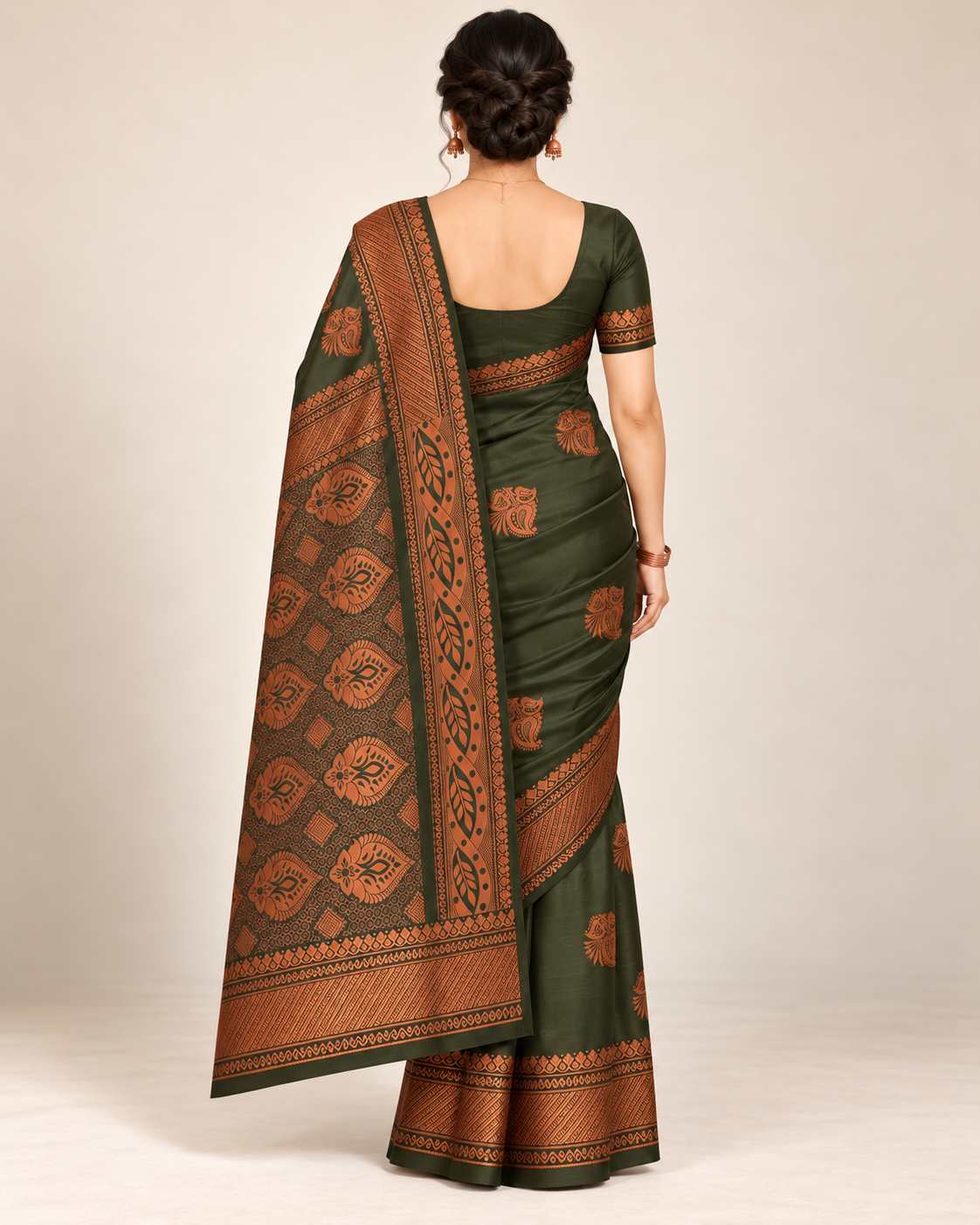 Rear view of an olive green silk saree with a naturally hanging copper pallu