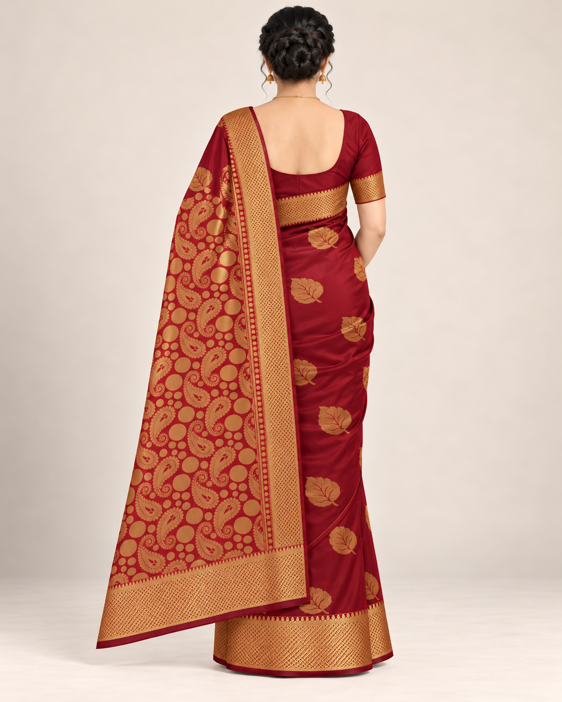 Rear view of a wine maroon silk saree with a gold paisley pallu