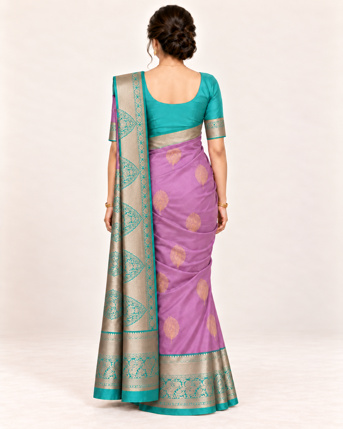 Rear view of lilac silk saree with gold feather motifs and turquoise metallic pallu