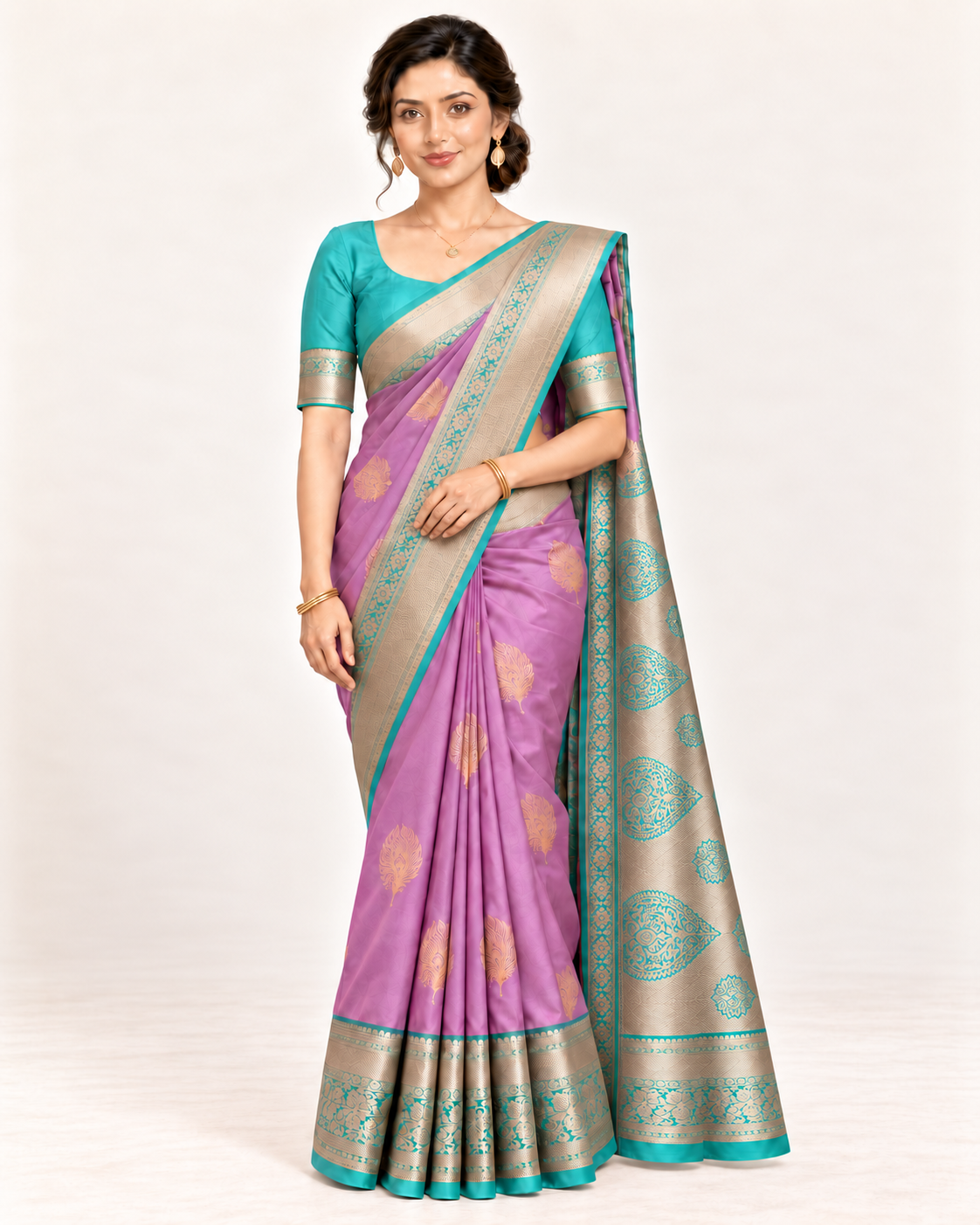 Lilac silk saree with turquoise blouse, gold border and jewellery in a relaxed studio pose