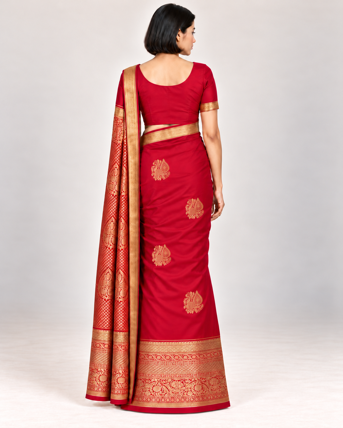 Rear view of ruby red silk saree with staggered gold peacock paisley motifs