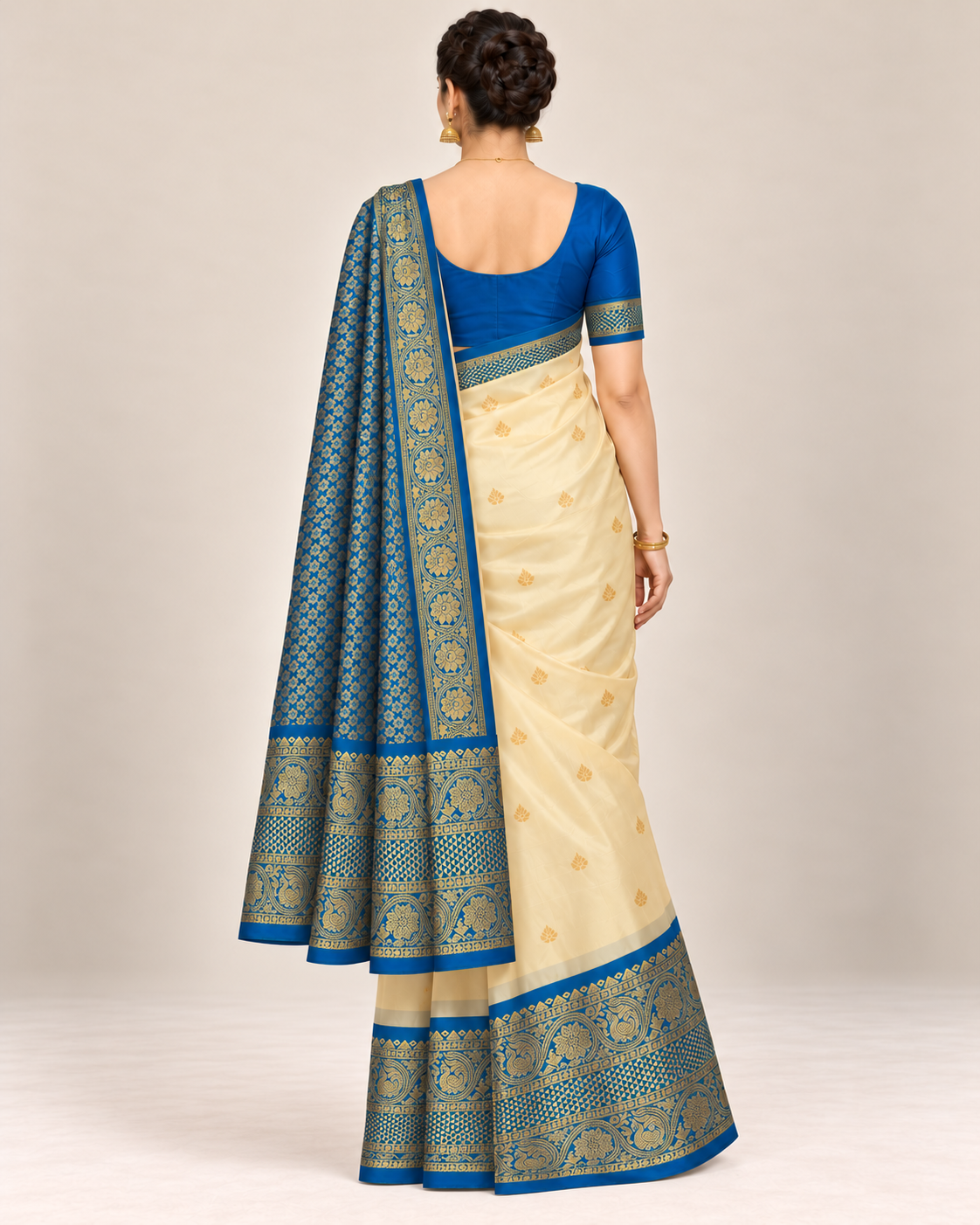 Rear view of cream and blue silk saree with patterned pallu