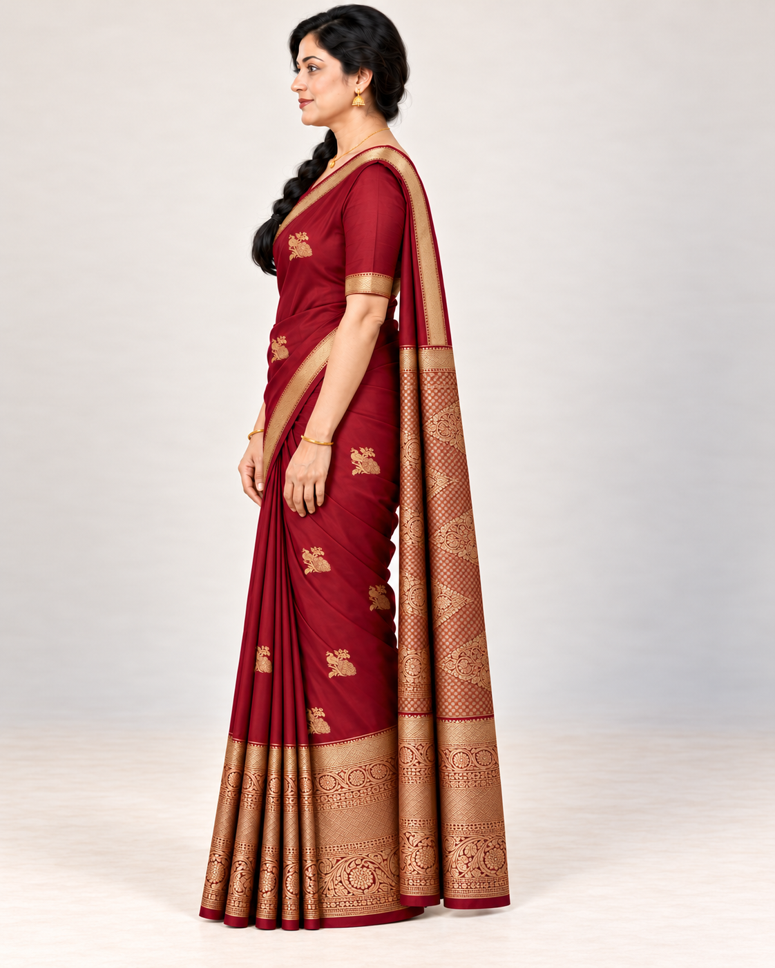 Side view of the wine red silk saree showing the drape and patterned pallu