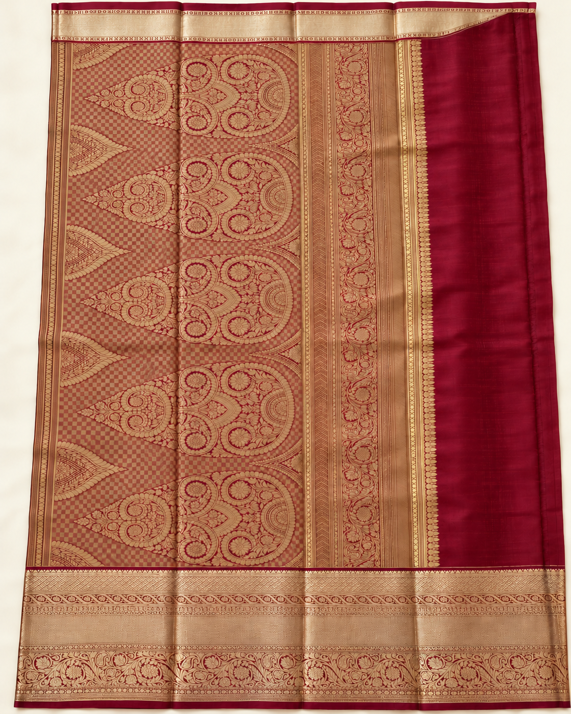 Spread pallu with gold crowned floral motifs and checkerboard weaving on wine red silk